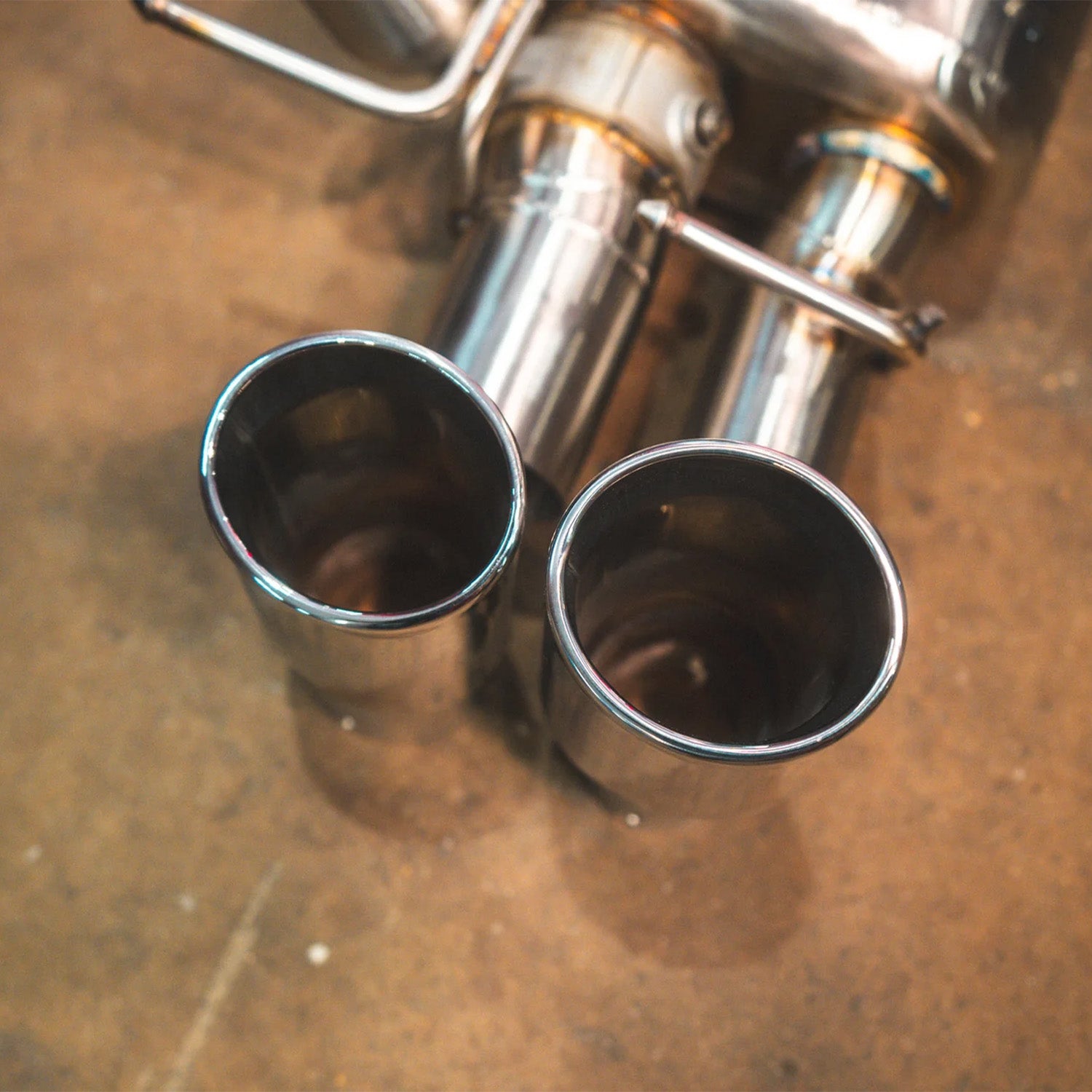 BMW E60 M5 Valvetronic Designs exhaust system on a concrete floor
