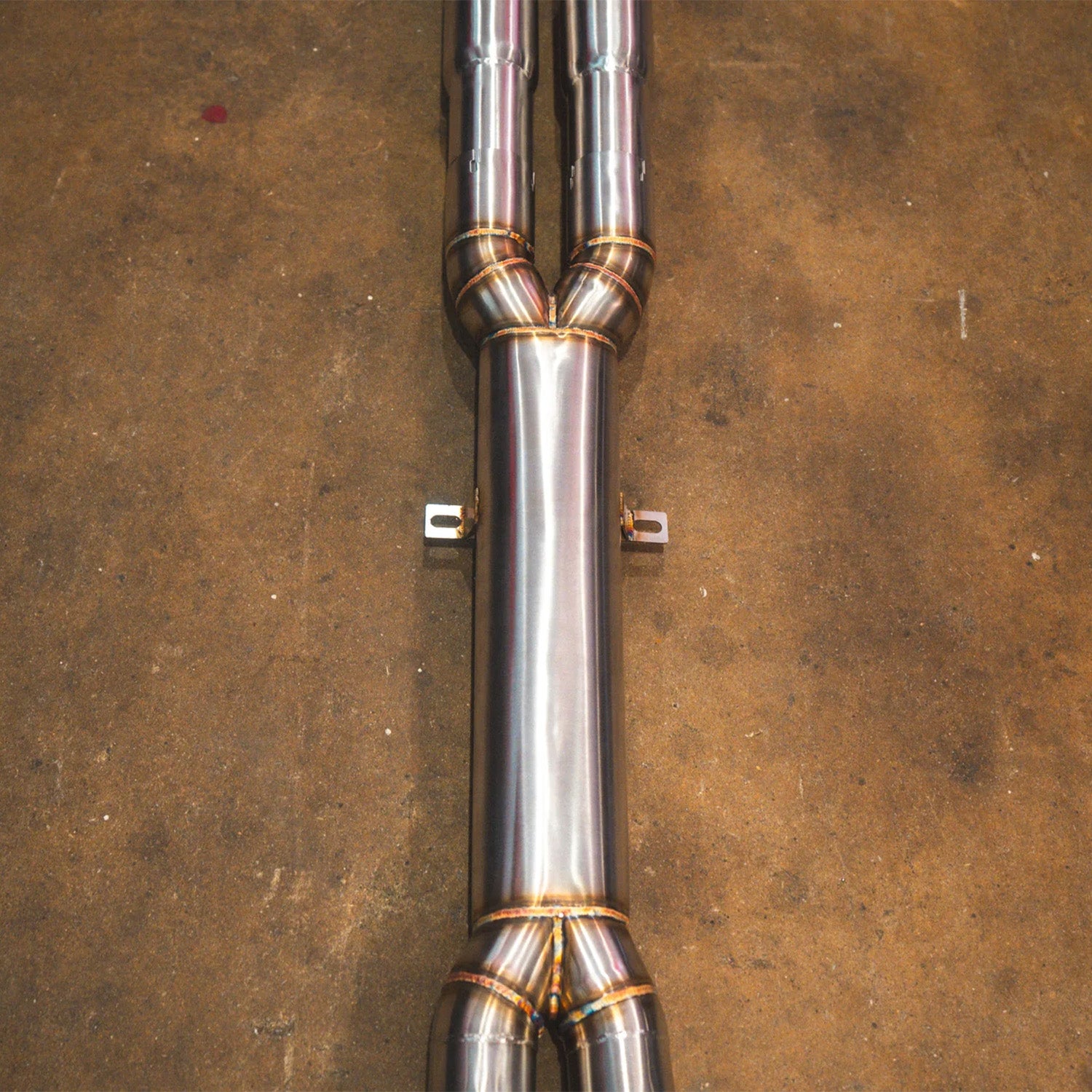 BMW E60 M5 Valvetronic Designs exhaust system on a concrete floor