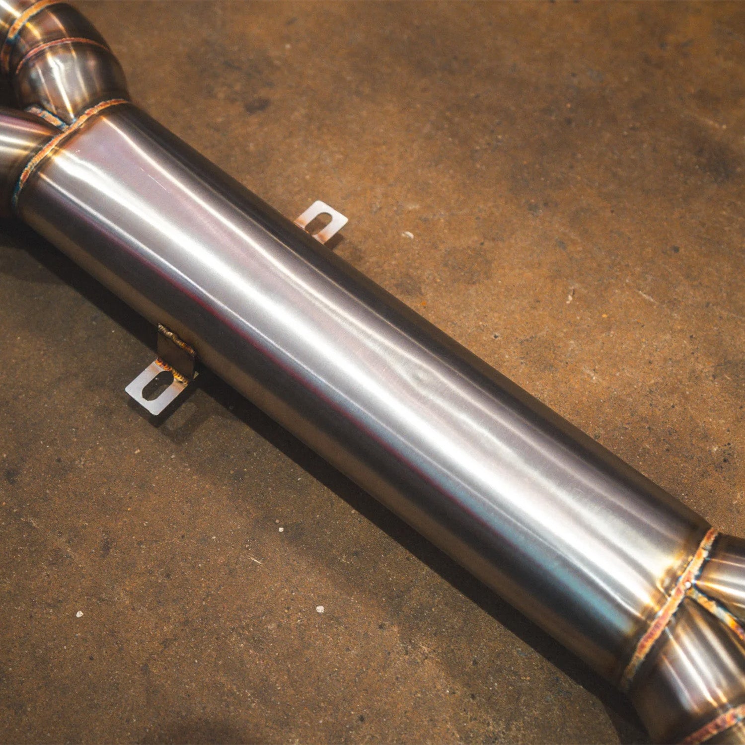BMW E60 M5 Valvetronic Designs exhaust system on a concrete floor