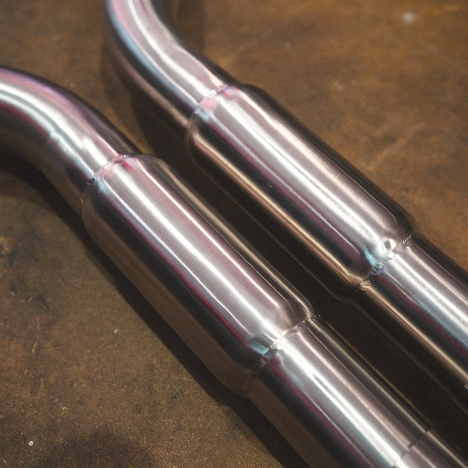BMW E60 M5 Valvetronic Designs exhaust system on a concrete floor
