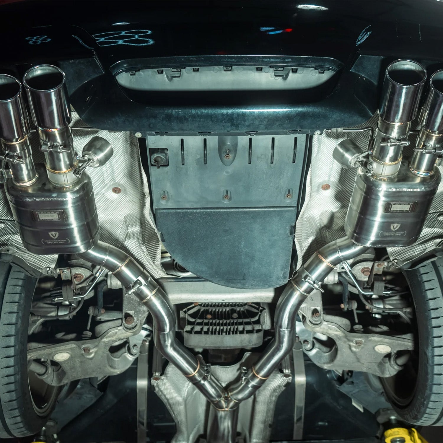 Close-up of a BMW E60 M5 Valvetronic exhaust system with visible branding.