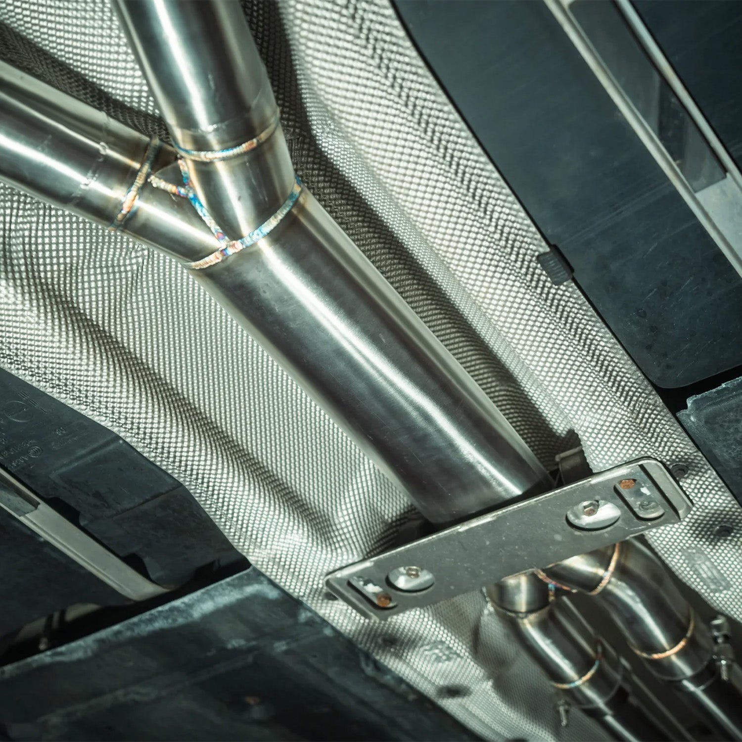 Close-up of a Valvetronic Designs exhaust system on a BMW E60 M5