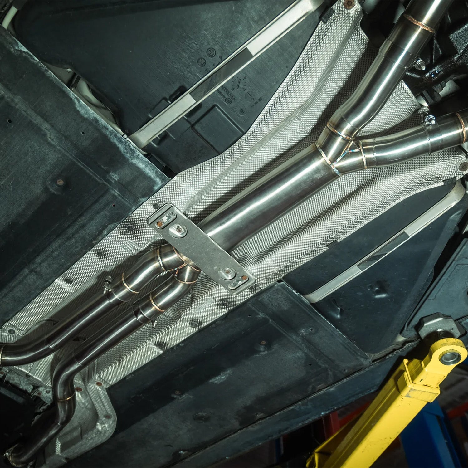 Close-up of a Valvetronic Designs exhaust system on a BMW E60 M5
