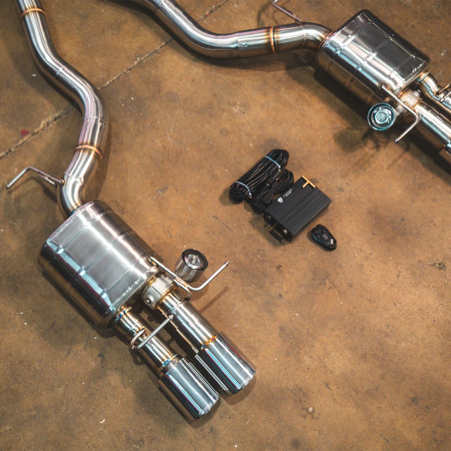 BMW E60 M5 Valvetronic Designs exhaust system on a concrete floor